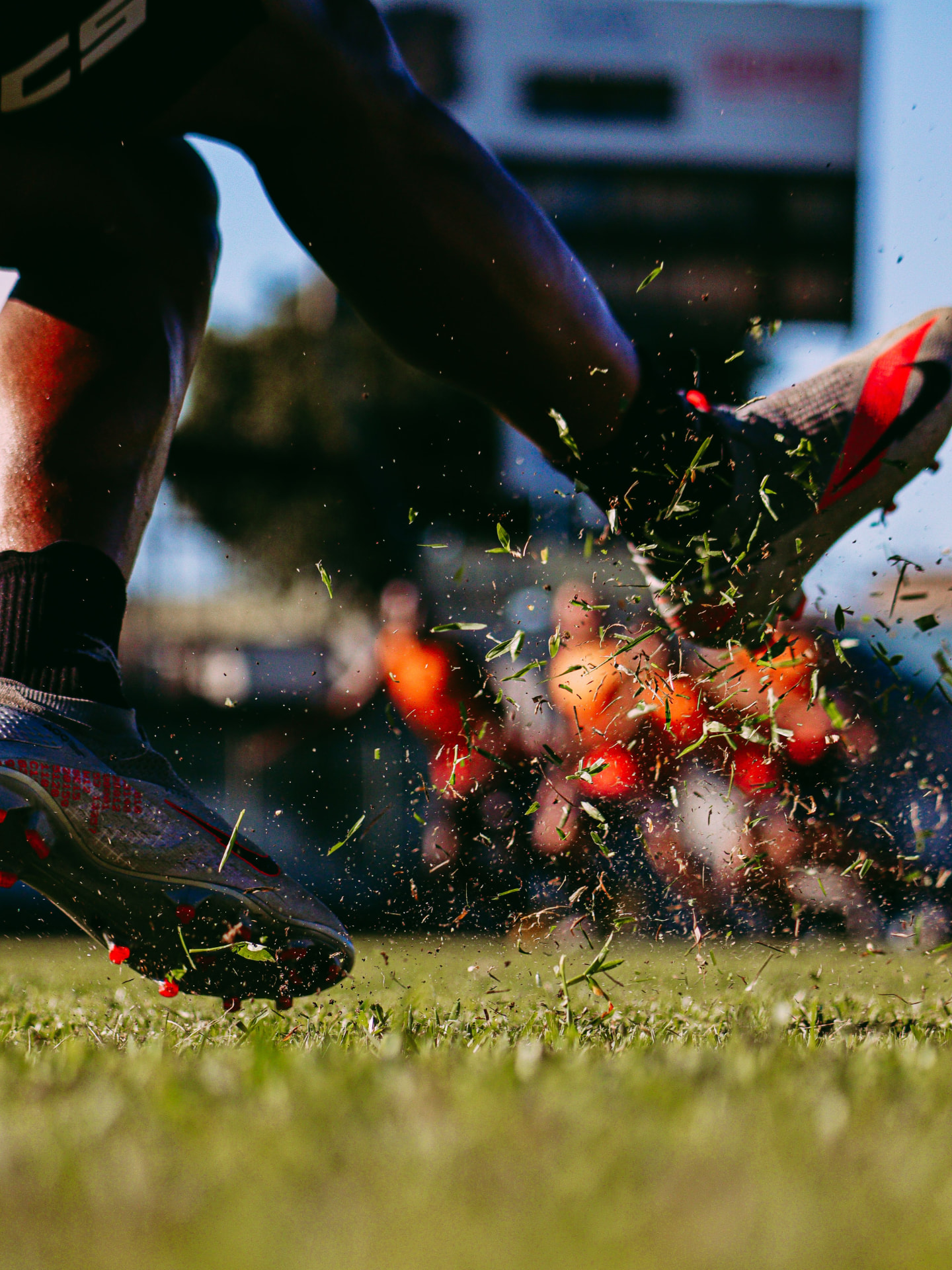 Youth soccer player striking a soccer ball on the field